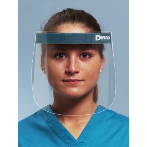 A woman wearing a surgical scrub top wearing a medical face shield.