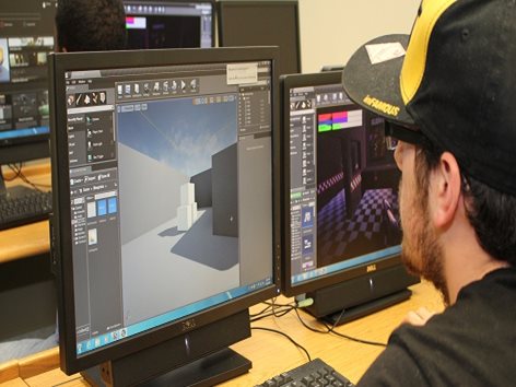 Student working at computer, using a graphics design program.