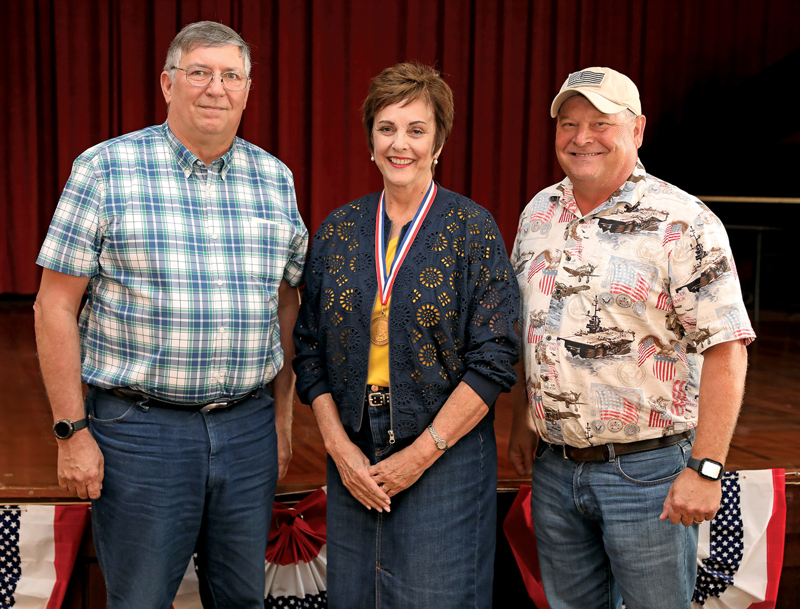 Three people standing together.
