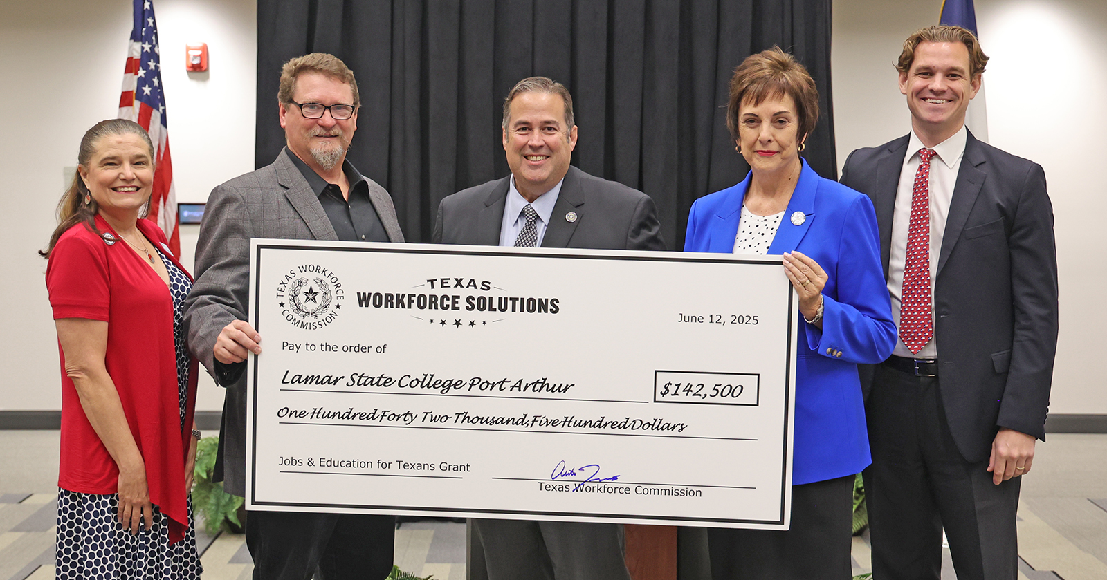Group of people holding a big check.