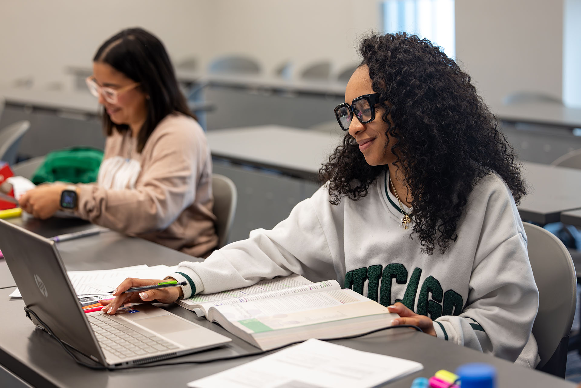 Woman works on computer in classroom
